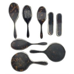 Various silver and tortoiseshell dressing table items comprising four hair brushes, two clothes brushes and two mirrors