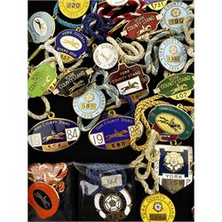 Seventy-five 1970s, 80s, 90s and early 2000s York enamel members' racecourse badges, together with a bronzed example for the year 2000 (76)