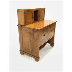 20th century satinwood side cabinet, with raised back fitted with cupboards, two deep drawers under, raised on panel end supports and castors, W84cm