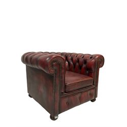 Chesterfield leather armchair, upholstered in deeply buttoned dark red leather, raised on turned bun feet 