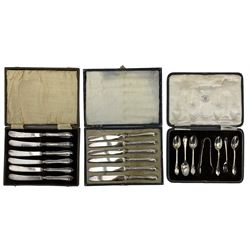 Two sets of six silver handled tea knives and a set of five silver teaspoons and tongs, all cased 