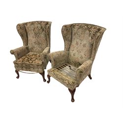 Parker Knoll - pair wingback armchairs upholstered in beige patterned fabric, raised on cabriole supports (one cushion missing)