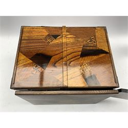 Early 20th century Japanese parquetry Tansu or travelling writing desk, the removable top flanked by four drawers and cupboard, strapwork hinges and patinated metal handles, L69cm, H27cm, D26cm 
