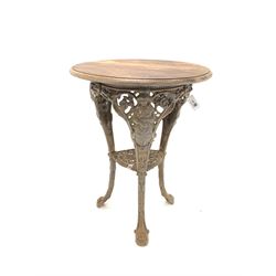 Heavy Victorian style cast iron Britannia pub table, circular moulded hardwood top over three supports united by under tier D62cm, H77cm