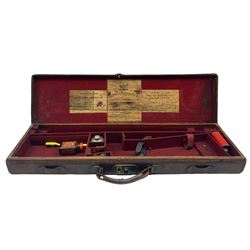 Leather shotgun case with the trade label of Westley Richards & Co., London containing various gun cleaning accessories and with a brass plaque inscribed 'T Nevin, Mirfield, Yorkshire' L83cm
