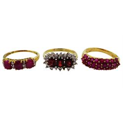 Gold three stone ruby ring, each ruby set with two diamonds between, gold garnet and cubic zirconia cluster ring and one other gold ruby three row ring, all hallmarked 9ct