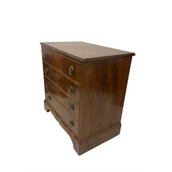 Mid-20th century walnut four drawer chest, raised on bracket supports 