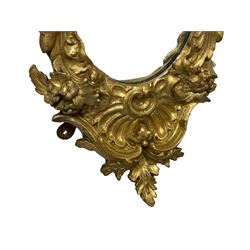 19th century wall mirror in Florentine giltwood and gesso frame, pierced c-scroll cartouche pediment decorated with flower heads, the scrolling foliage moulded frame decorated with flowers, terminating to shell and leaf motifs 
