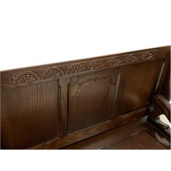Mid 20th century oak Monks bench, the panelled metamorphic top over box seat with hinged lid, the arm rests carved in the shape of lions, the front carved with lunettes and fluted columns, on bracket feet