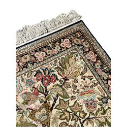 Iranian silk and cotton rug, the pale golden field decorate with tree of life with perching birds, trailing branches with foliate decoration, the main guarded border with repeating design decorated with flower heads