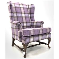 20th century Queen Anne style wingback armchair, upholstered in purple tartan wool, raised on cabriole front supports united by shaped 'H' stretcher W81cm