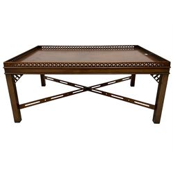 Chippendale design mahogany coffee table, rectangular top with pierced fretwork gallery, on square supports united by pierced cross stretcher