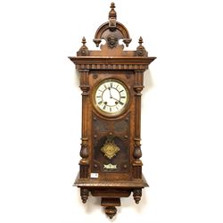Quality Victorian walnut cased Vienna style regulator wall clock, the arched pediment with turned finials and applied mask decoration, over two half round fluted and leaf carved pilasters, white enamel dial with Roman chapter ring, decorative gilt metal pendulum, eight day movement striking two hammers on two coils, H112cm