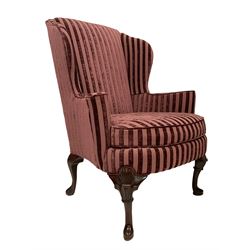 Queen Anne design mahogany framed wingback armchair, upholstered in striped purple fabric with sprung seat and loose seat cushion, raised on cabriole supports with applied shell decoration