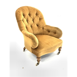  Victorian button back upholstered armchair, raised on turned beech supports and castors, W71cm  