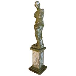 20th century cast stone two-piece garden figure in the form of Venus de Milo or Aphrodite of Melos, on a square plinth the stepped base, decorated with oval floral panels within Greek key borders 