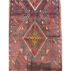 Meshwani indigo and maroon ground runner rug, the field with three lozenges with central amber roods and polygon borders, the border with geometric shapes