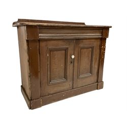 Victorian scumbled pine standing cupboard, raised back over rectangular top with rounded corners, fitted with two panelled doors enclosing single shelf, on plinth base