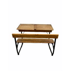 Mid 20th century oak school desk, the top with ink well recesses and two hinged compartments, folding seat, raised on tubular base W91cm