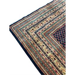 Persian Arrak navy ground carpet, the field decorated profusely with small Boteh motifs, multiple border bands with repeating geometric designs  