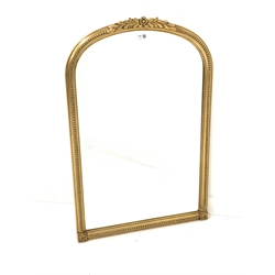 20th century gilt framed wall mirror, the arched frame with beaded and floral moulding enclosing bevelled plate 