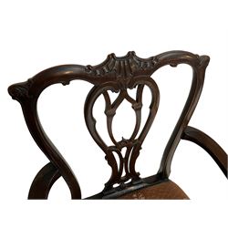 George III mahogany elbow chair, shaped shell carved cresting rail over open pierced splat carved with foliage, shaped arms with acanthus carved terminals, upholstered seat with stud band and gadroon moulded edge, on acanthus and scroll carved cabriole legs with ball and claw feet 