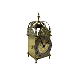 A 20th century spring driven table clock in the style of an early 17th century Lantern clock, with an eight-day striking movement and lever platform escapement, striking the hours and half hours on a bell, with a 5” silvered chapter ring, Roman numerals, half hour markers and quarter hour division track.


