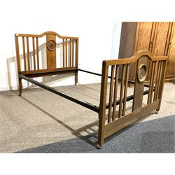 Early 20th century oak 4' 6'' double bedstead, the slatted head and footboard carved with acanthus leaf roundels, raised on later castors 