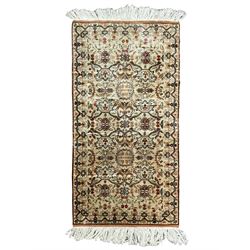 Small Persian ivory ground silk inlaid finely woven rug, the busy field decorated with interlacing floral decoration and stylised palmette motifs, trailing border with connecting plant designs with an outer amber guard