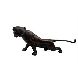 Early 20th century Japanese bronze model of a snarling tiger, with glass eyes and brown & red patina L42.5cm