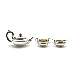  Silver three piece teaset of circular form, the teapot with ebonised handle and lift London 1915 Maker Henry Hodson Plante 40oz gross  
