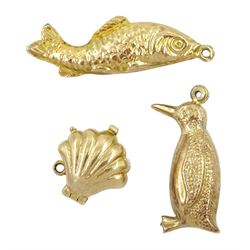 Three 9ct gold charms including penguin, pearl clam shell and fish, all hallmarked