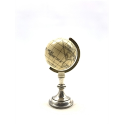 19th century ivory Terrestrial Globe with incised and black stained detail,  with spun brass bezel and later white metal stand, H8.5cm