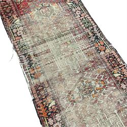 Persian Hamadan runner, the field decorated with seven geometric medallions and surrounded by smaller geometric motifs, the border decorated with stylised plants 