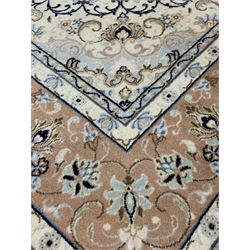 Persian Meshad hand knotted ivory ground carpet, centred by lozenge medallion and decorated with scrolled foliate, 305cm x 200cm