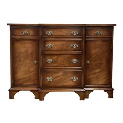 Walnut breakfront side cabinet, the breakfront top over four graduated drawers, flanked by two cupboards and two drawers, raised on bracket supports 