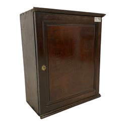 George III oak hanging wall cupboard, single panelled door enclosing three spice drawers over two shelves, with two drawers fitted to base, lower moulded edge