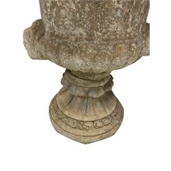  Reconstituted stone garden urn with foliate decoration and bearded masks raised on base with floral decoration