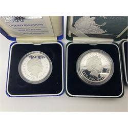 The Royal Mint United Kingdom silver proof 2007 one ounce Britannia, silver proof 2007 twenty-pence Britannia, silver proof 2000 five pound coin, all cased with cert, and two one ounce fine silver Britannia coins dated 2008, 2010 in card holders
