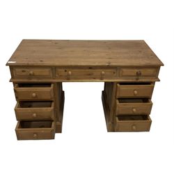 20th century traditional pine twin pedestal desk, fitted with nine drawers with turned handles, on skirted base