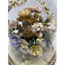 Victorian painted shell work bouquet of flowers, arranged in a wicker basket, incorporating dried flowers and stiffened fabric foliate, under glass dome on brass feet, H38cm 