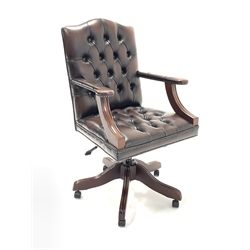 20th century captains chair, seat and back upholstered in buttoned and studded brown leather, open and upholstered arm rests, raised on swivel base, W64cm