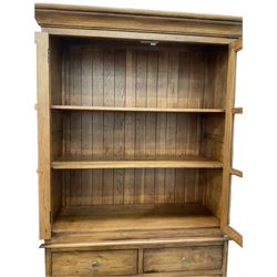Oak bookcase on chest, the bookcase fitted with two shelves over two drawers and two cupboards, raised on a plinth base W120cm, D50m, H210cm
