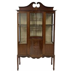 Edwardian mahogany display cabinet, moulded swans neck pediment, the frieze decorated with lozenge band, reverse bow front astragal glazed door over opposing bow front panelled cupboard inlaid with urn, two flanking glazed and panelled doors, on square tapering supports with spade feet