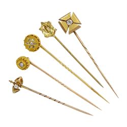 Four Victorian gold diamond stick pins including flower cluster and single stone cross of approx 0.15 carat and a gilt citrine pin
