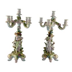 Pair of 19th/ early 20th century four branch candelabra, each decorated with encrusted flowers and foliage, the bases modelled as male and female figures, on scroll supports, unmarked, H45cm 