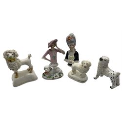Group of 19th century Staffordshire poodle dog models, with shredded clay fur, a recumbent model of a dog on an oval base, H9cm and smaller, together with two porcelain half dolls