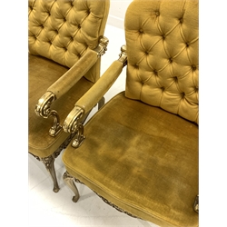 Pair of Italian cast brass open armchairs, seat and back upholstered in yellow velvet, the frame with scrolled floral decoration, raised on cabriole supports, W55