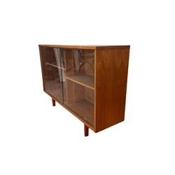 Teak bookcase with two sliding glass doors enclosing shelves, reproduction yew wood hanging filling cabinet, tooled leather inset top over two drawers, raised on bracket supports and a Georgian style mahogany cupboard on cupboard in the style of a cupboard on chest, fitted with one slide and a drawer  