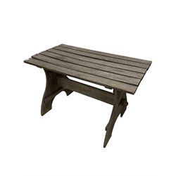 Teak garden table, the slatted top raised on panel end supports, united by stretcher 